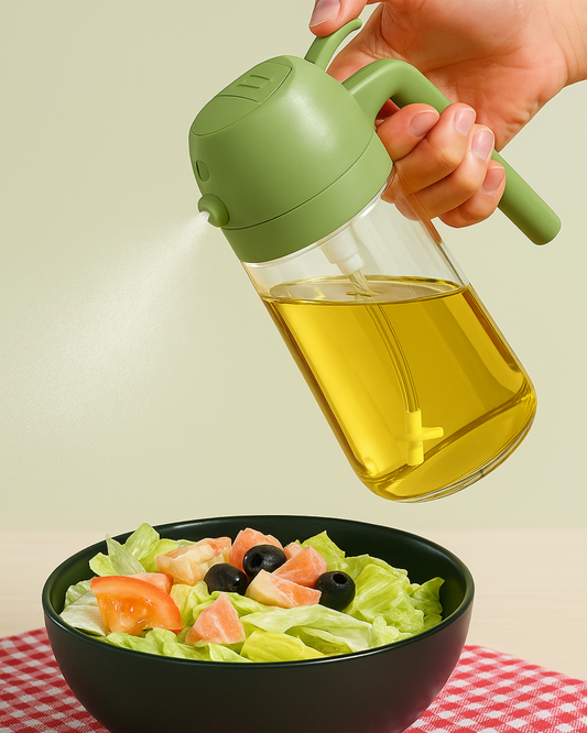 Green oil sprayer being used on a salad