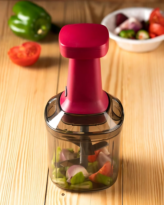 Vegetable chopper with red handle on wooden surface