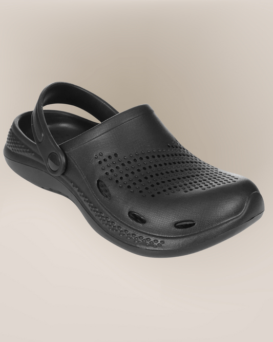 Black clog shoe on a beige background