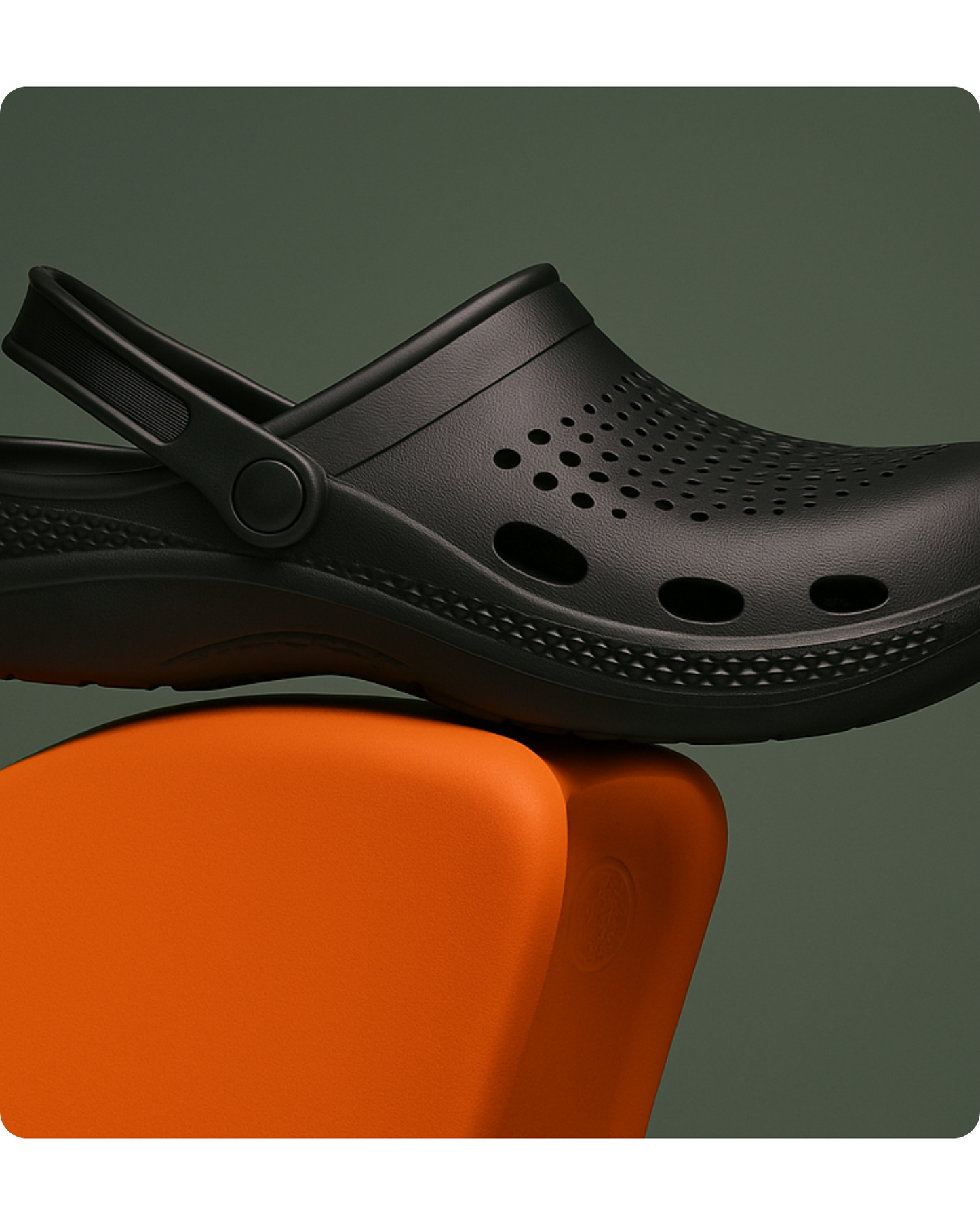 Black clog shoe on an orange surface with a dark gray background