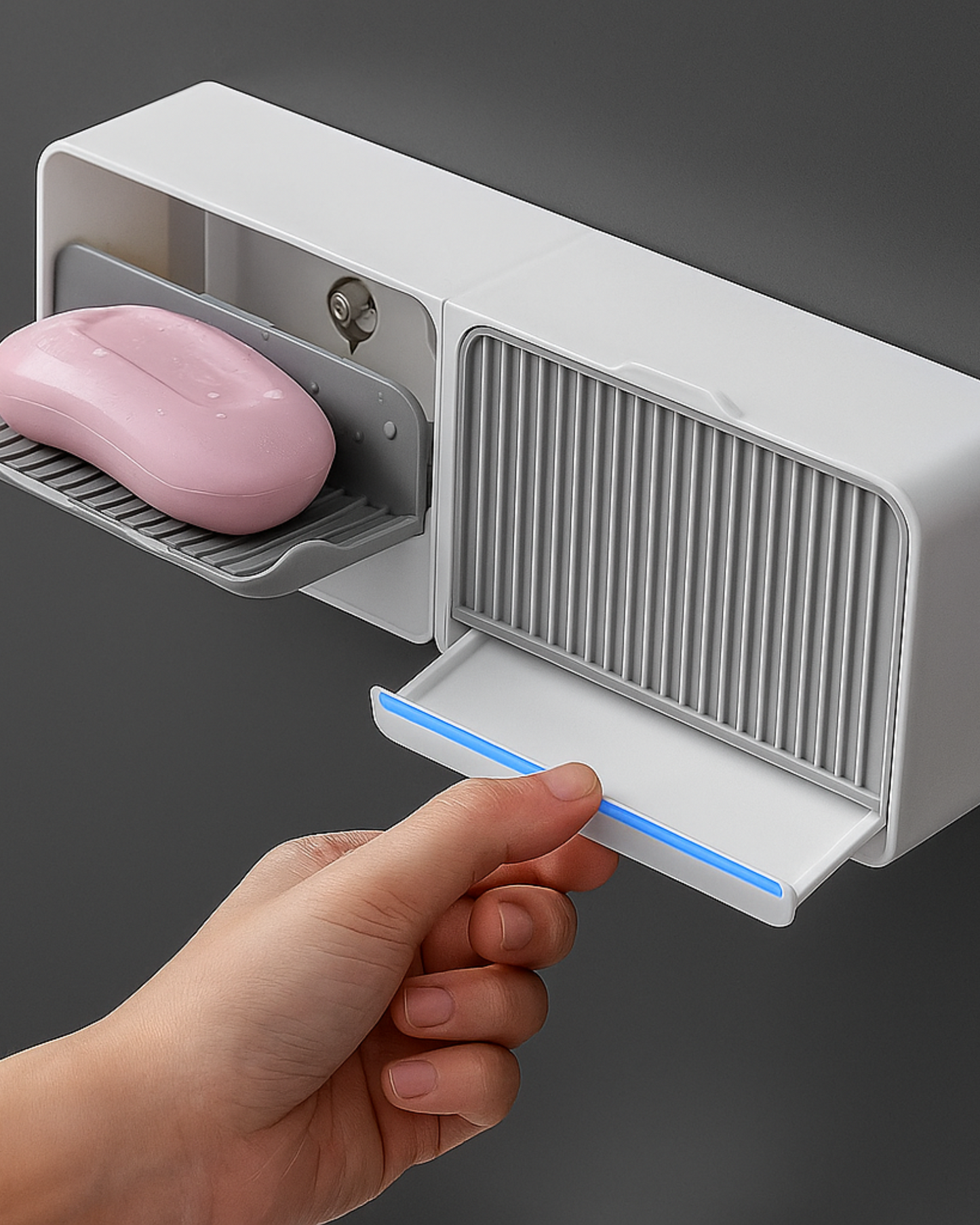 Hand holding a soap bar above a white soap dispenser with a gray background