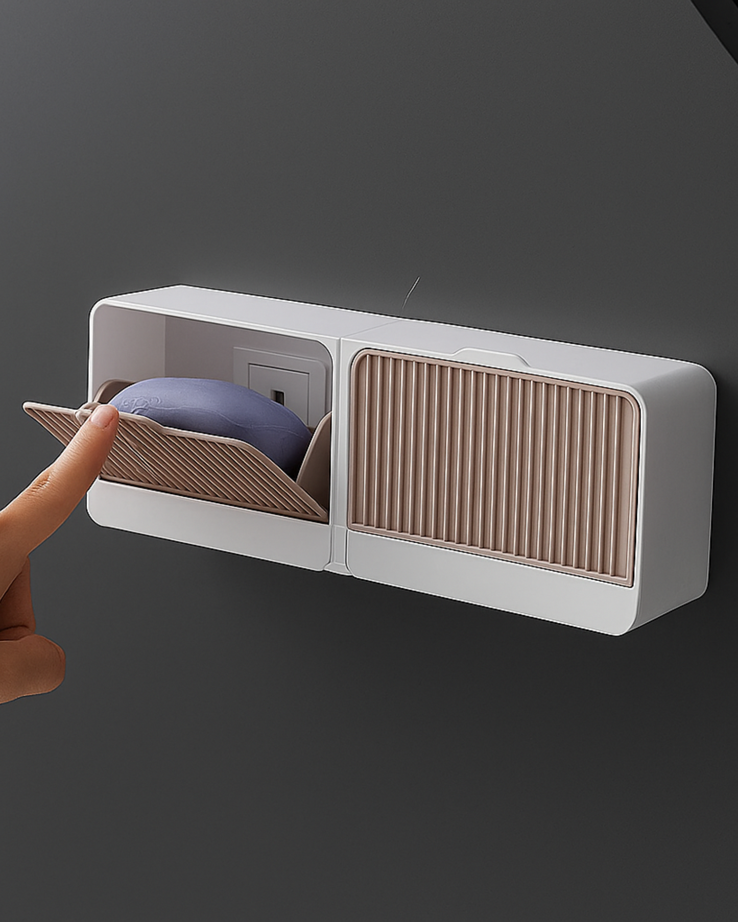 Wall-mounted shoe storage unit with a hand opening one of the compartments.