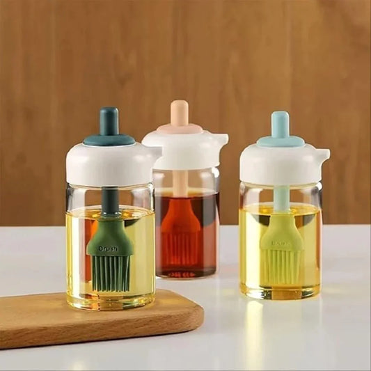 Three glass bottles with colorful caps and brush attachments on a wooden surface.