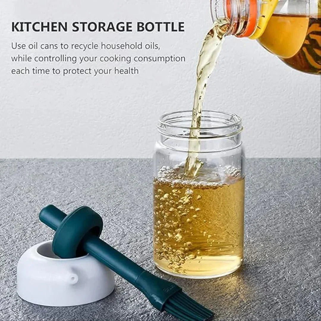 Kitchen storage bottle with oil being poured into a jar on a gray surface.