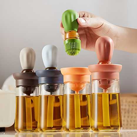 Set of glass bottles with colorful silicone lids being held by a hand.