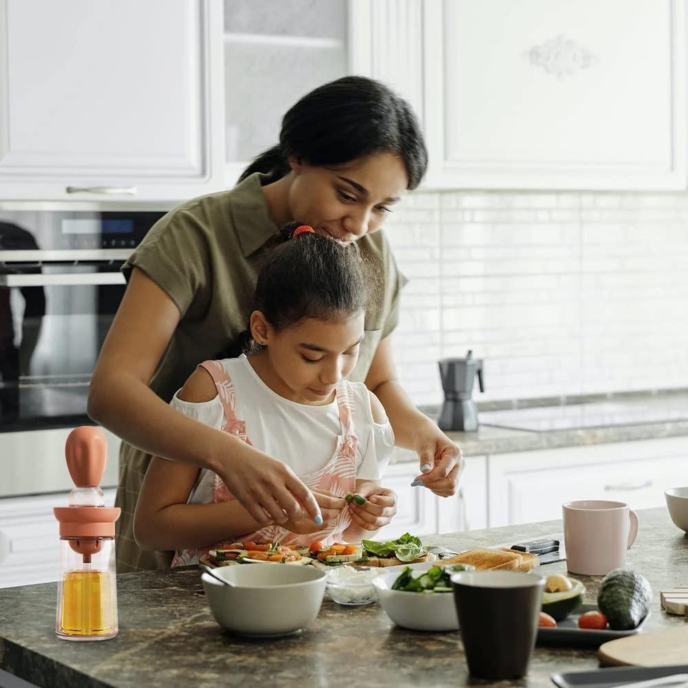 Woman and young girl preparing food together in a kitchen