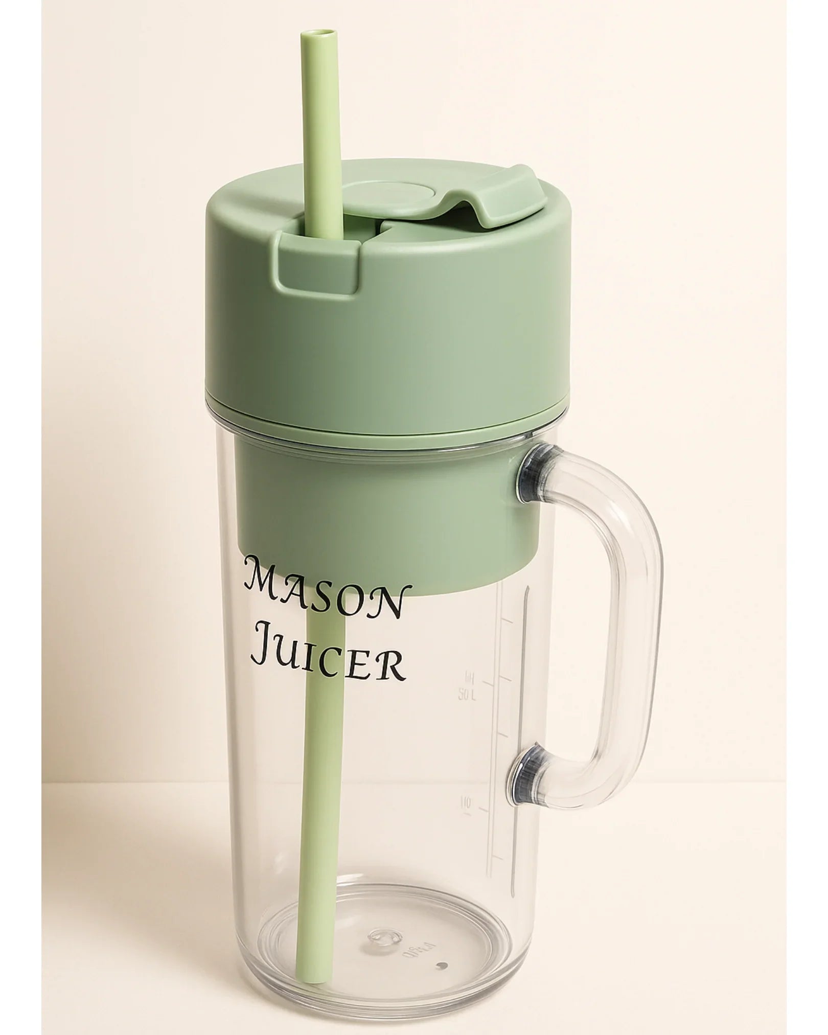 Mason Juicer with green lid and straw on a beige background