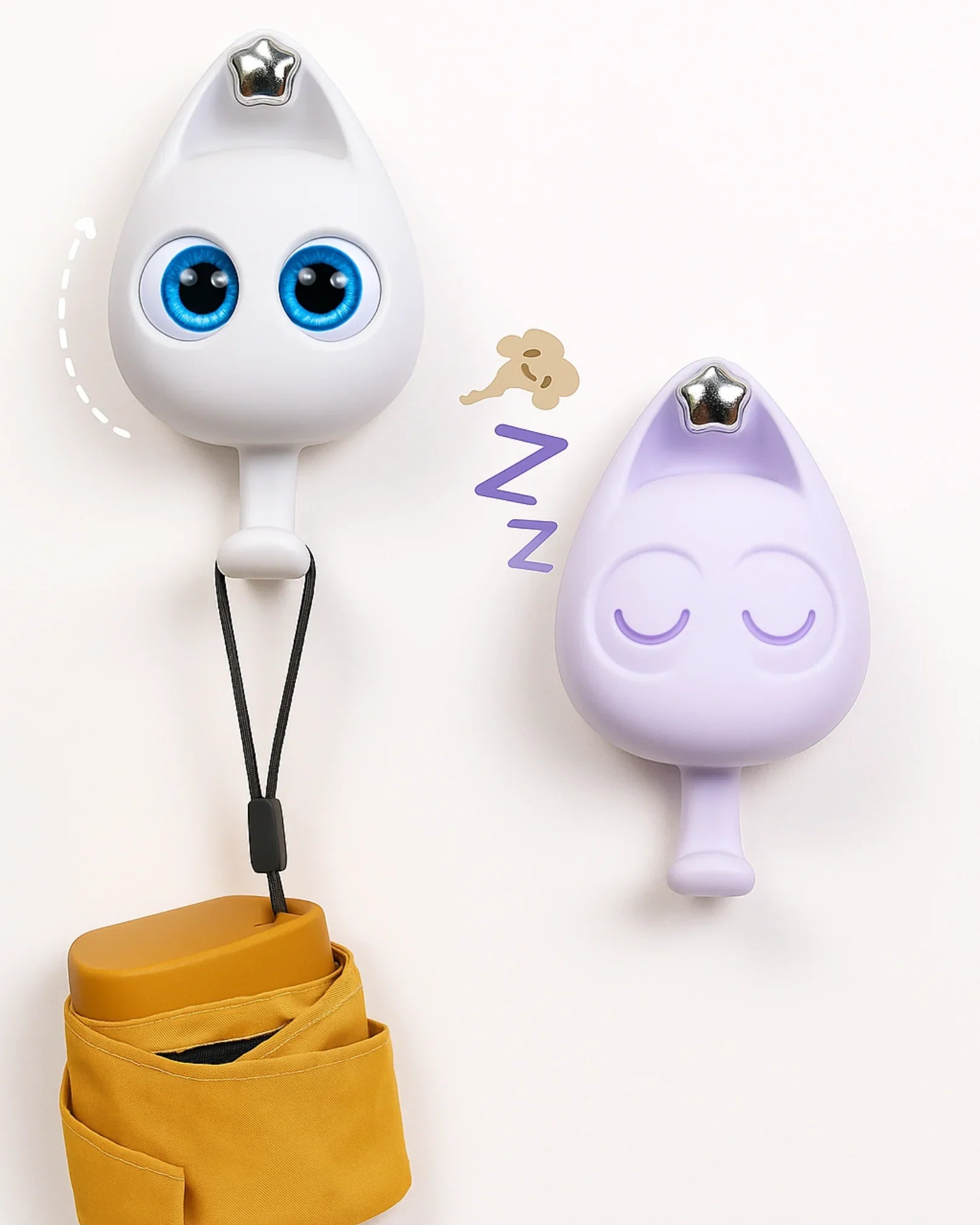 Two cartoonish raindrop-shaped hooks with eyes and a sleeping face, one white with blue eyes and the other purple with a sleeping face, on a white background.