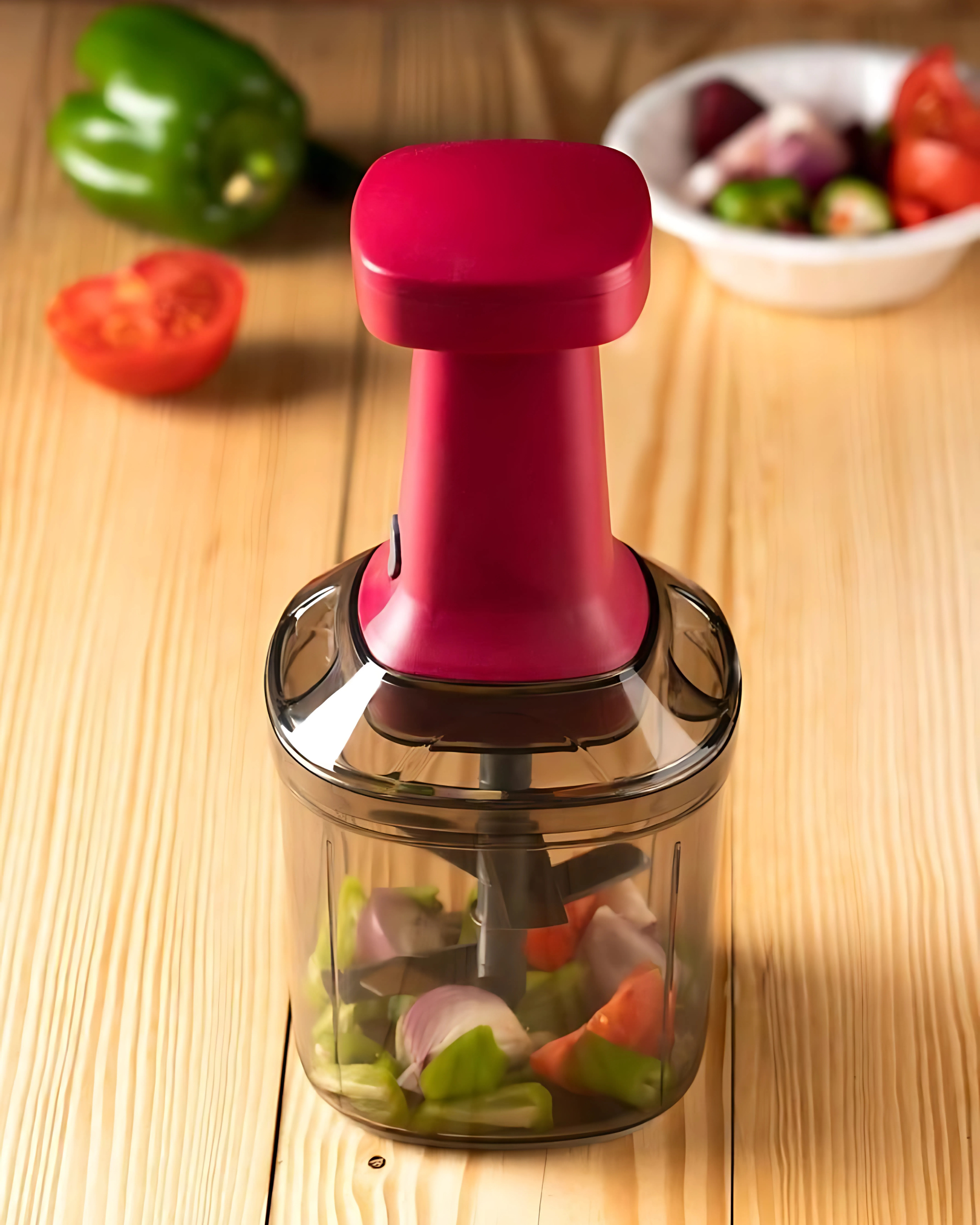 Vegetable chopper with red handle on wooden surface