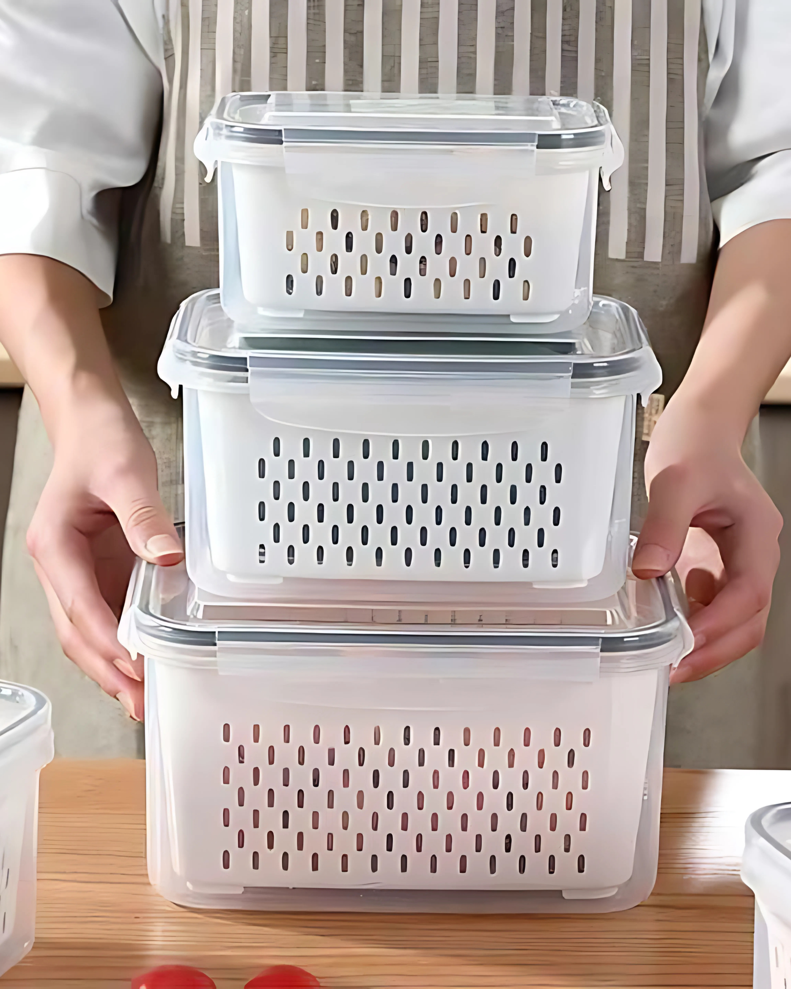 Stack of clear plastic storage containers with lids on a wooden surface.