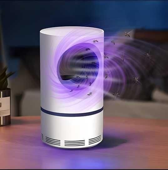Mosquito killer lamp emitting purple light with mosquitoes around it on a wooden surface.