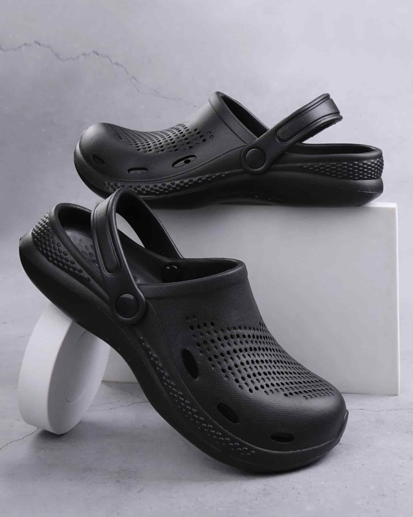 Black clogs on a light gray background
