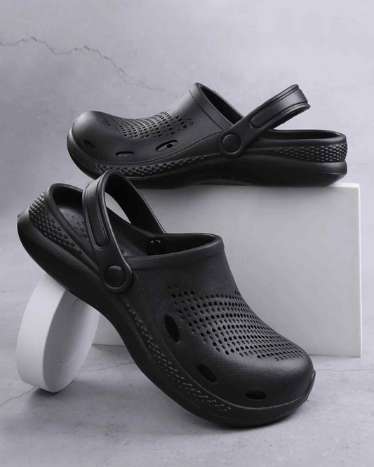 Black clogs on a light gray background
