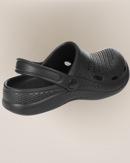 Black clog shoe on a beige background
