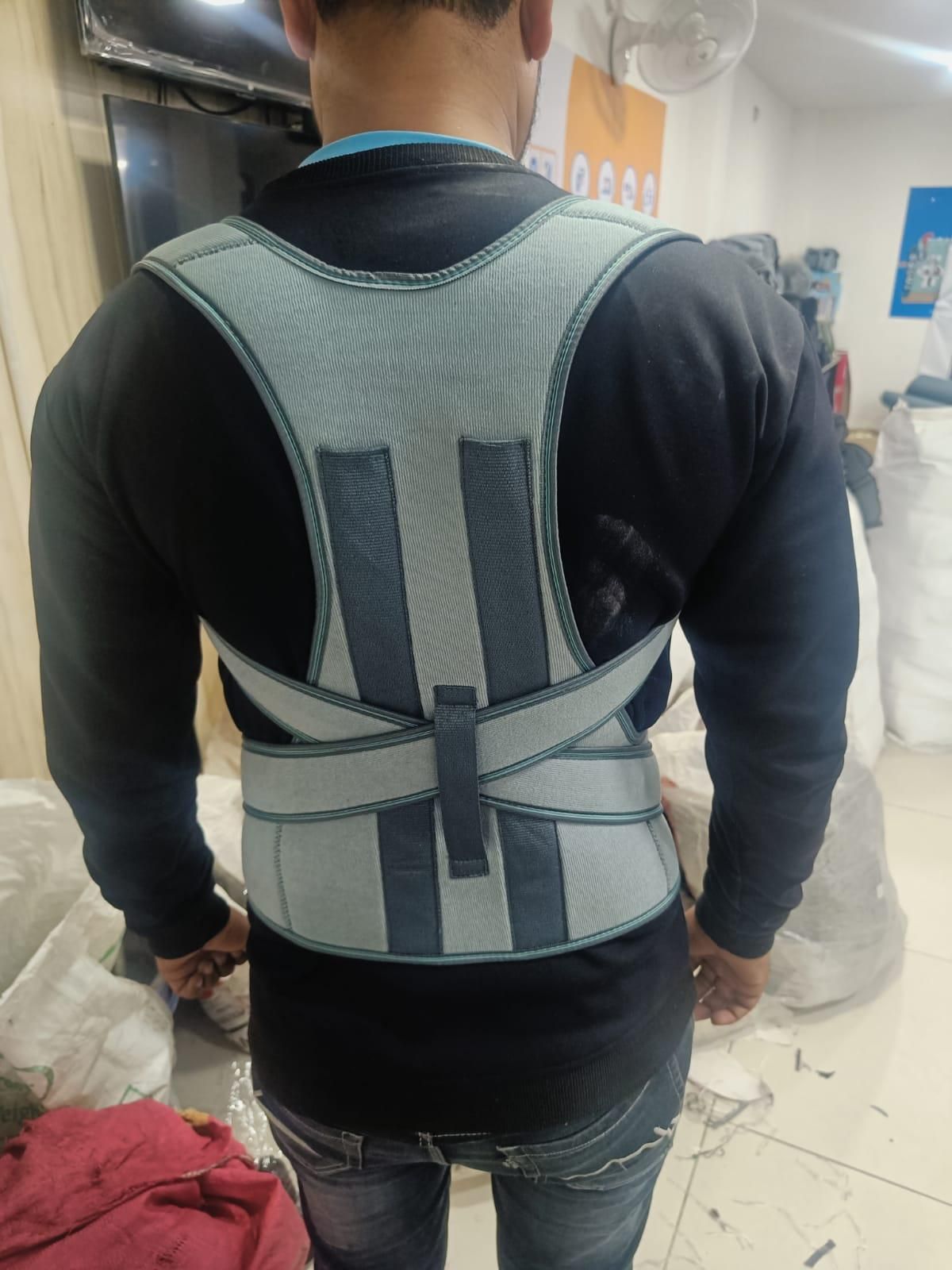 Person wearing a back brace in an indoor setting