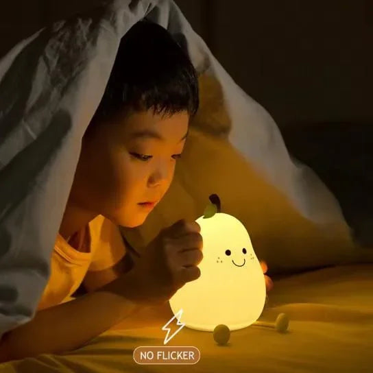 Child lying under a blanket with a glowing pear-shaped night light.