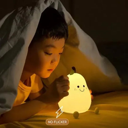 Child lying under a blanket with a glowing pear-shaped night light.