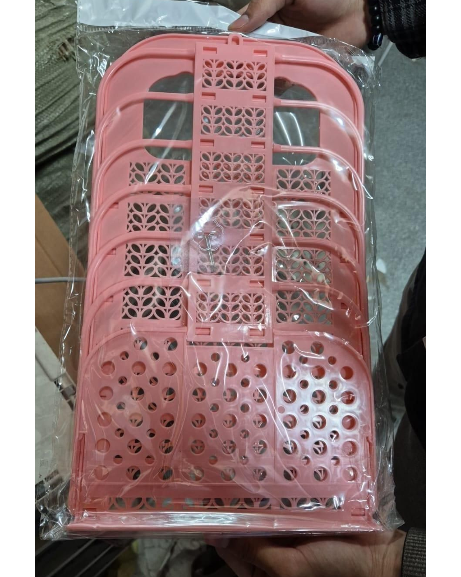 Pink plastic basket with cut-out design in clear packaging